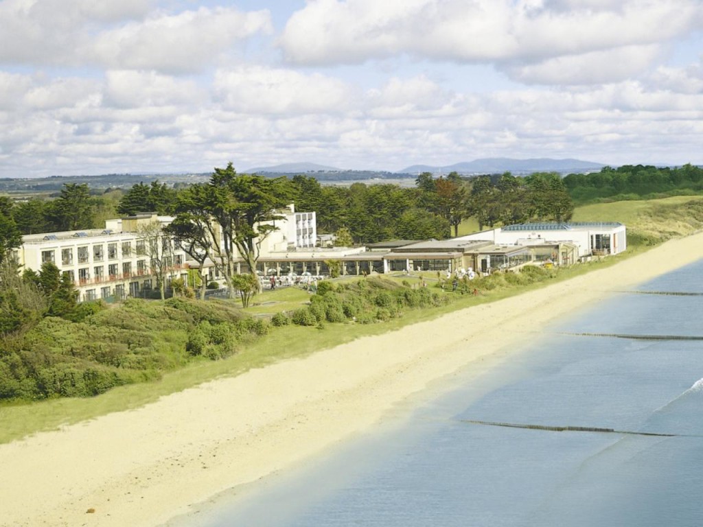 Aerial view of Kelly's Resort Hotel's exterior and coastline