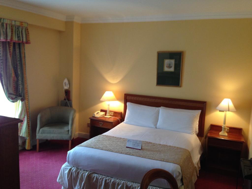 A spacious, ambient double bedroom in Grafton Capital Hotel
