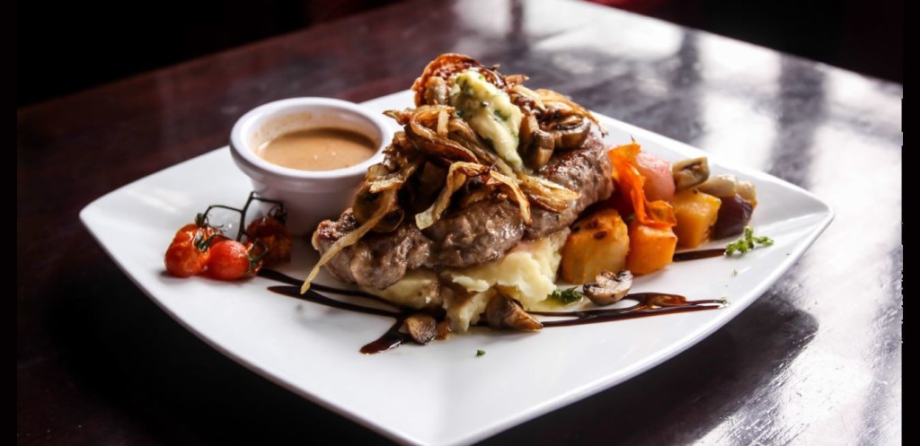 Delicious grilled vegetables topped with tender meat in Parnell Heritage Bar and Grill