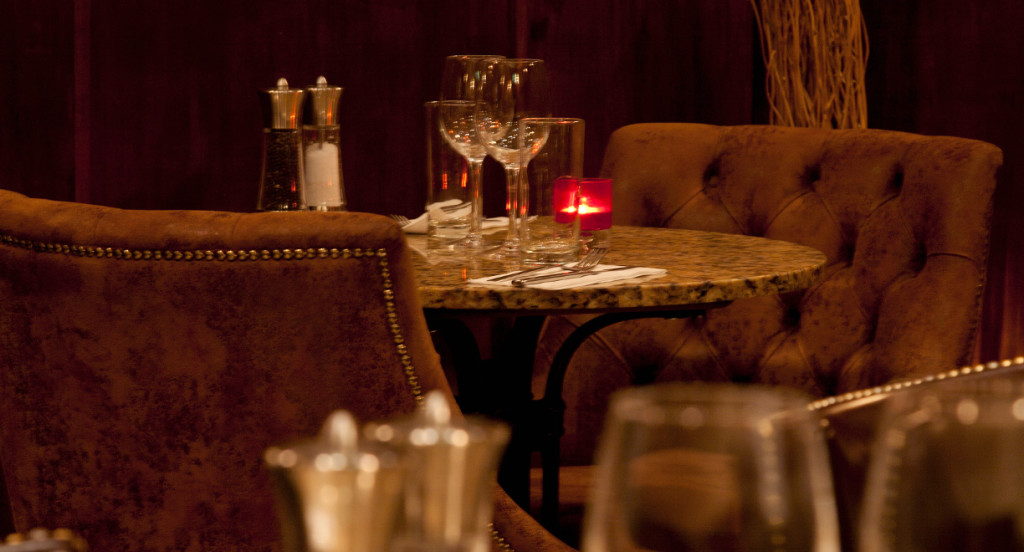 An intimate, warm dining table at Le Bon Crubeen