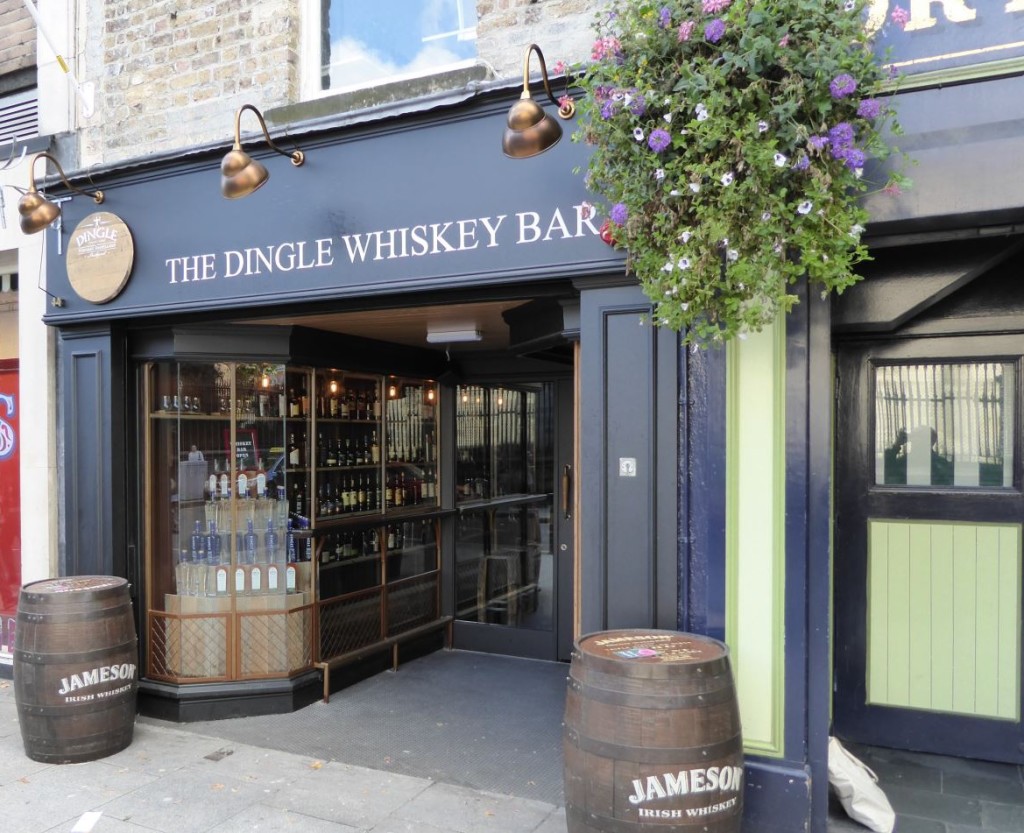 The barrel-flanked entrance of The Dingle Whiskey Bar